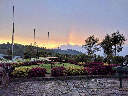 Sri Lanka's hill country - a rainbow is visible in the background